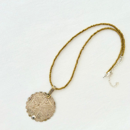 Brass necklace with large antique Moroccan silver flower pendant